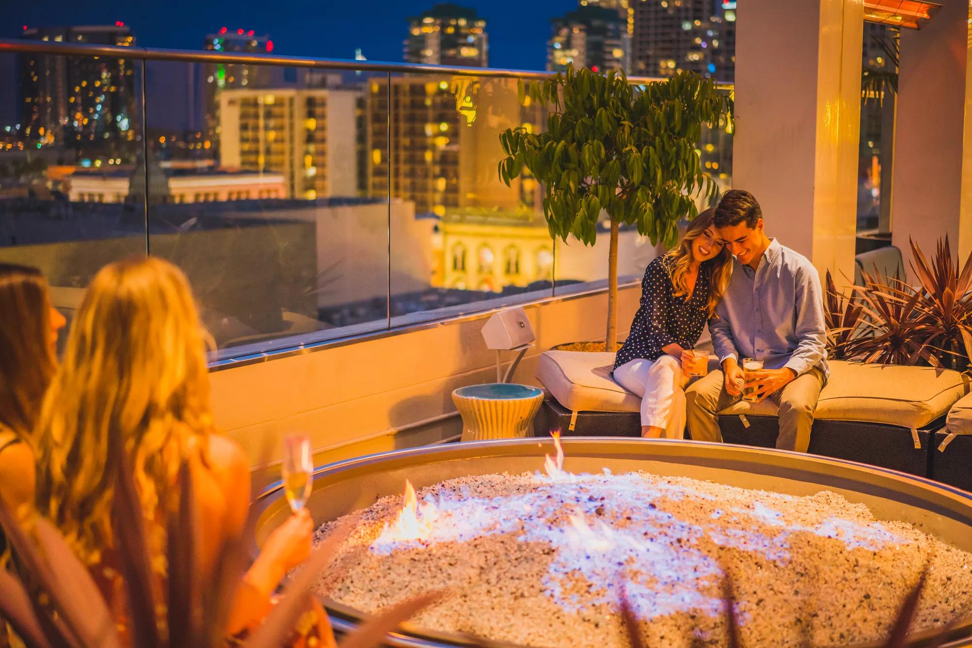 A couple having drinks on the Andaz Hotel Rooftop, San Diego, California