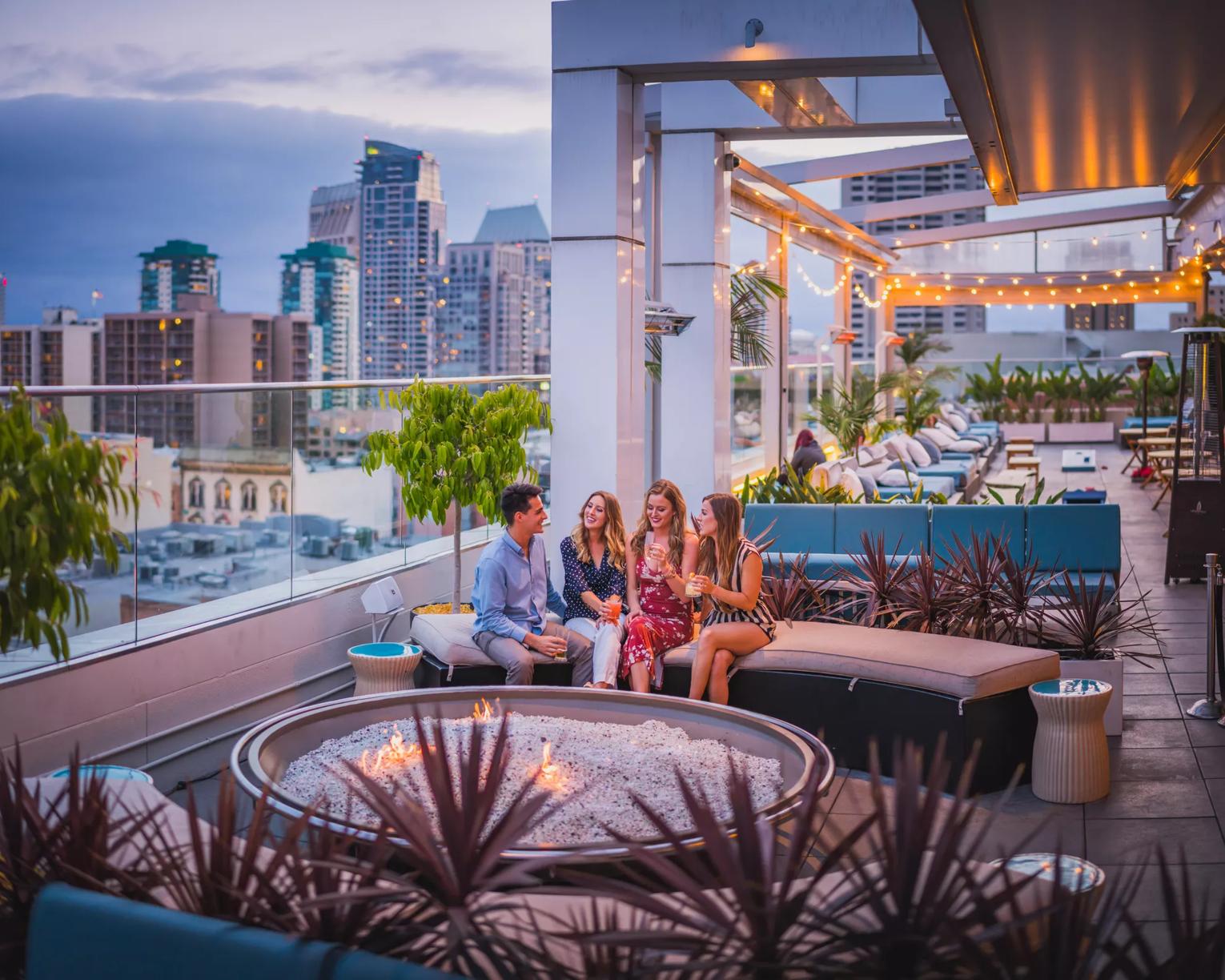 Friends having drinks on the Andaz Hotel Rooftop, San Diego, California