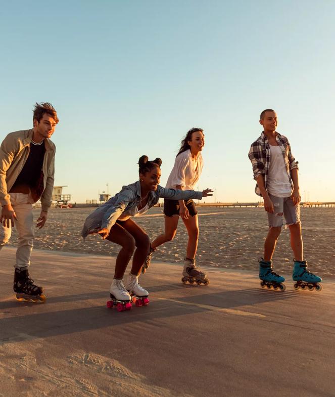Stock image by  LeoPatrizi taken in Venice Beach, CA, in April 2018.
4 friends roller-skate along Venice Beach in Santa Monica, CA during sunset.