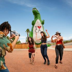 A band takes silly group photos in front of the Cabazon Dinosaurs. Shot as part of the 2024 Playful Journeys/Up Around The Bend brand campaign.