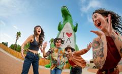 A band takes silly photos together in front of the Cabazon Dinosaurs. Shot was taken as part of the 2024 Road Trips Up Around the Bend/Playful Journeys Brand campaign shoot.