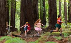 Kids running through the redwoods dressed to represent their own personalities as part of the 'Childhood Rules' spot