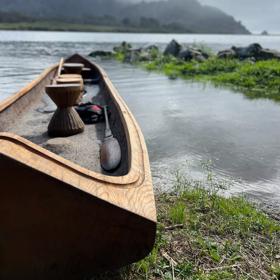 A canoe resting on the water on a misty day in Del Norte County, Ca.