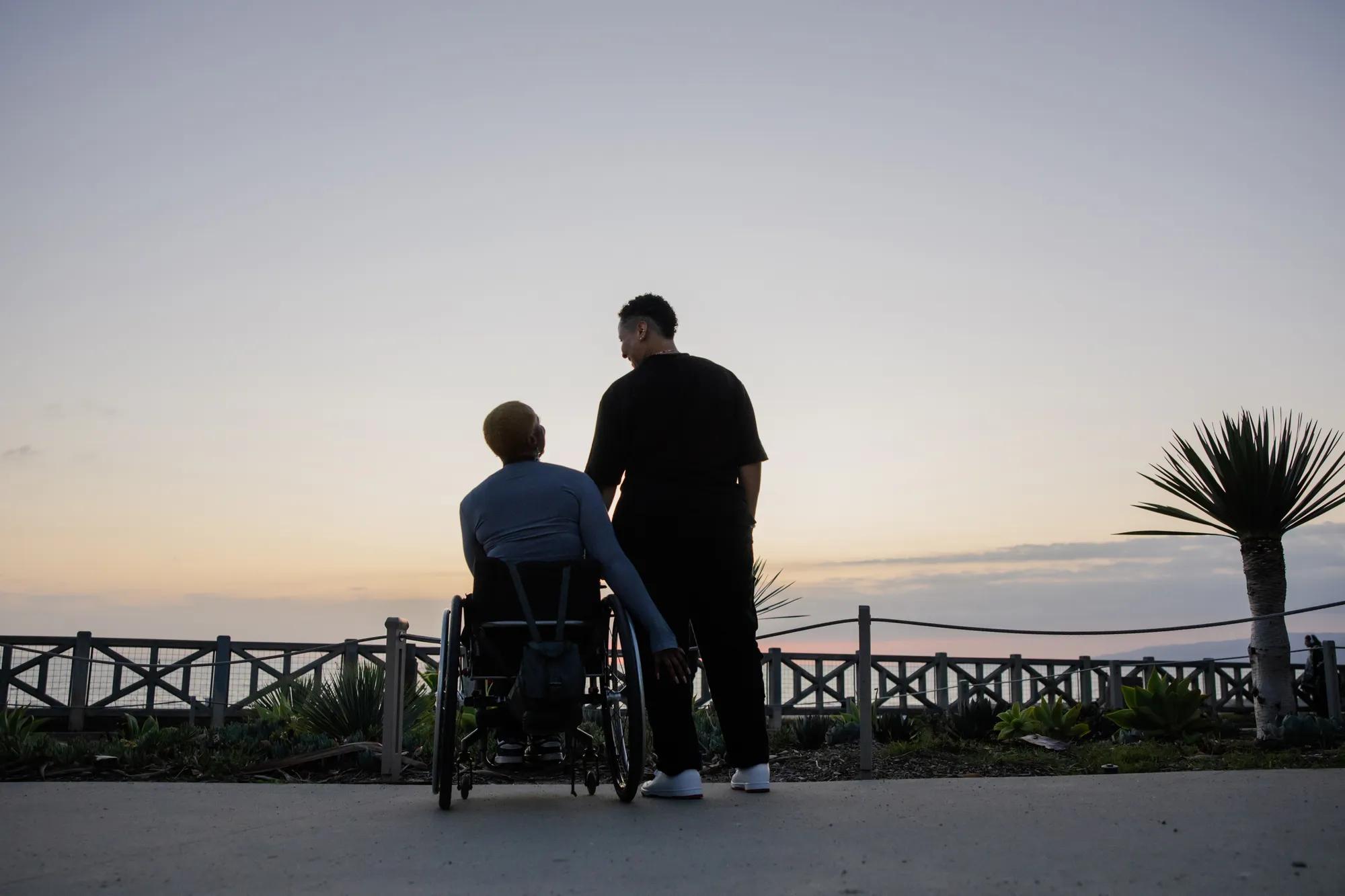 Two Friends by the Sunset, Embracing On a Wheelchair by the Path
Two individuals share a serene moment at sunset by a pathway near the ocean, highlighting friendship, inclusivity, and the beauty of nature. A wheelchair emphasizes themes of companionship and accessibility.

Image #6726091